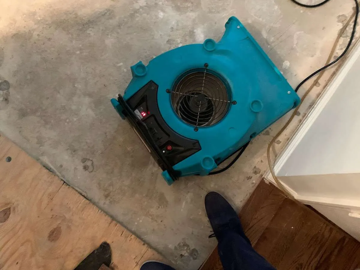 Air mover drying subfloor during Commercial Water Damage Restoration in Somers